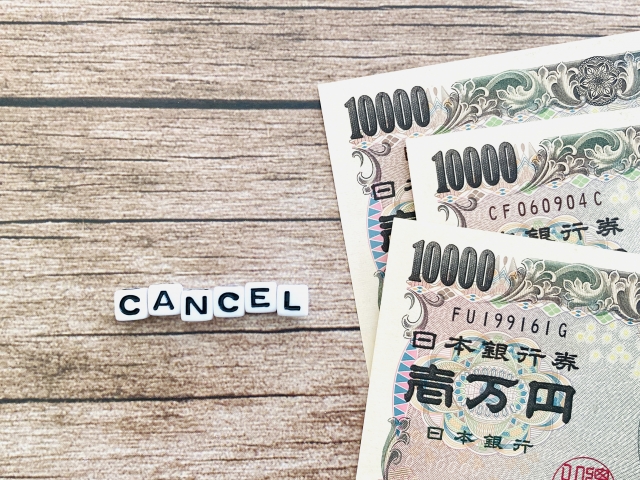 3万円札とCANCELのサイコロ